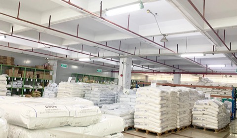 Raw material warehouse stocked with 300 tons of TPU and other raw materials showing organized storage and inventory for manufacturing operations