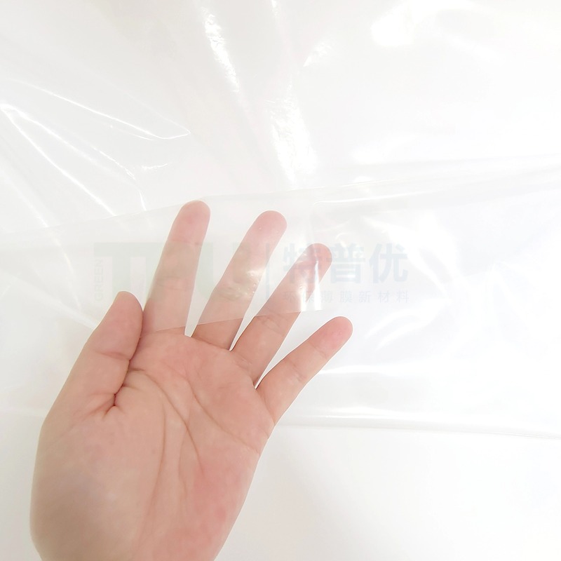 Transparent TPU film applied to car door panels for laminating decorative fabric onto plastic substrates offering flexible durable and reliable bonding material